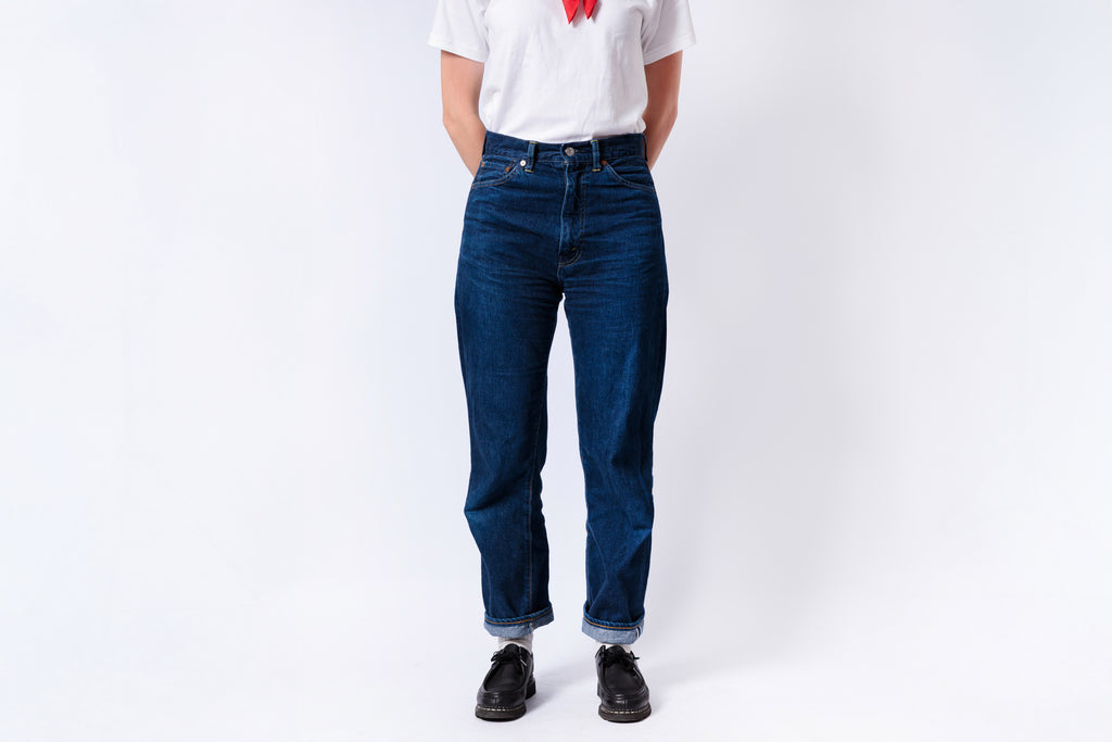 Person wearing blue jeans and a white t-shirt on a white background