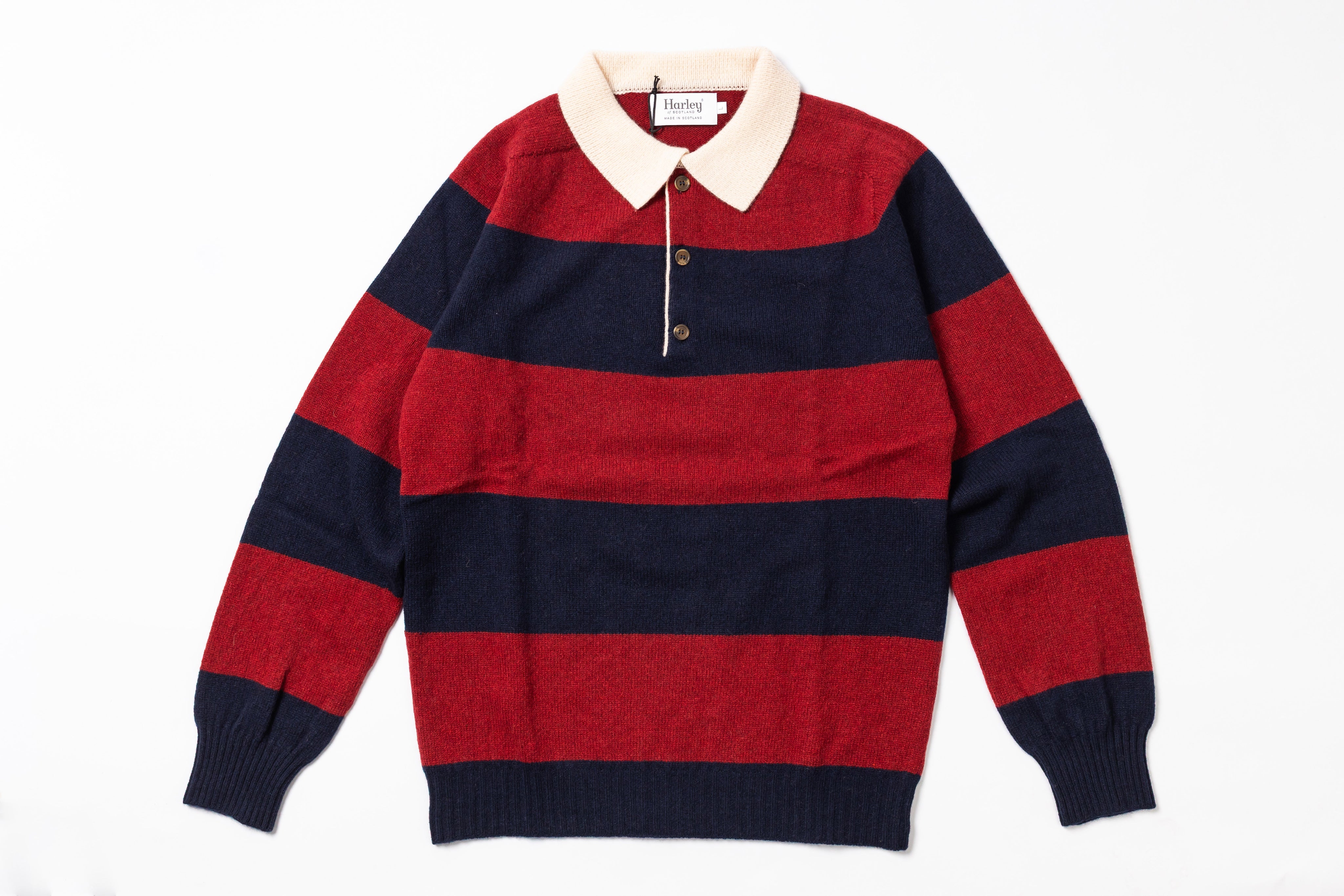 Red and navy striped sweater with a white collar on a white background