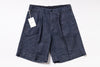 Pair of dark denim shorts with a tag on a white background