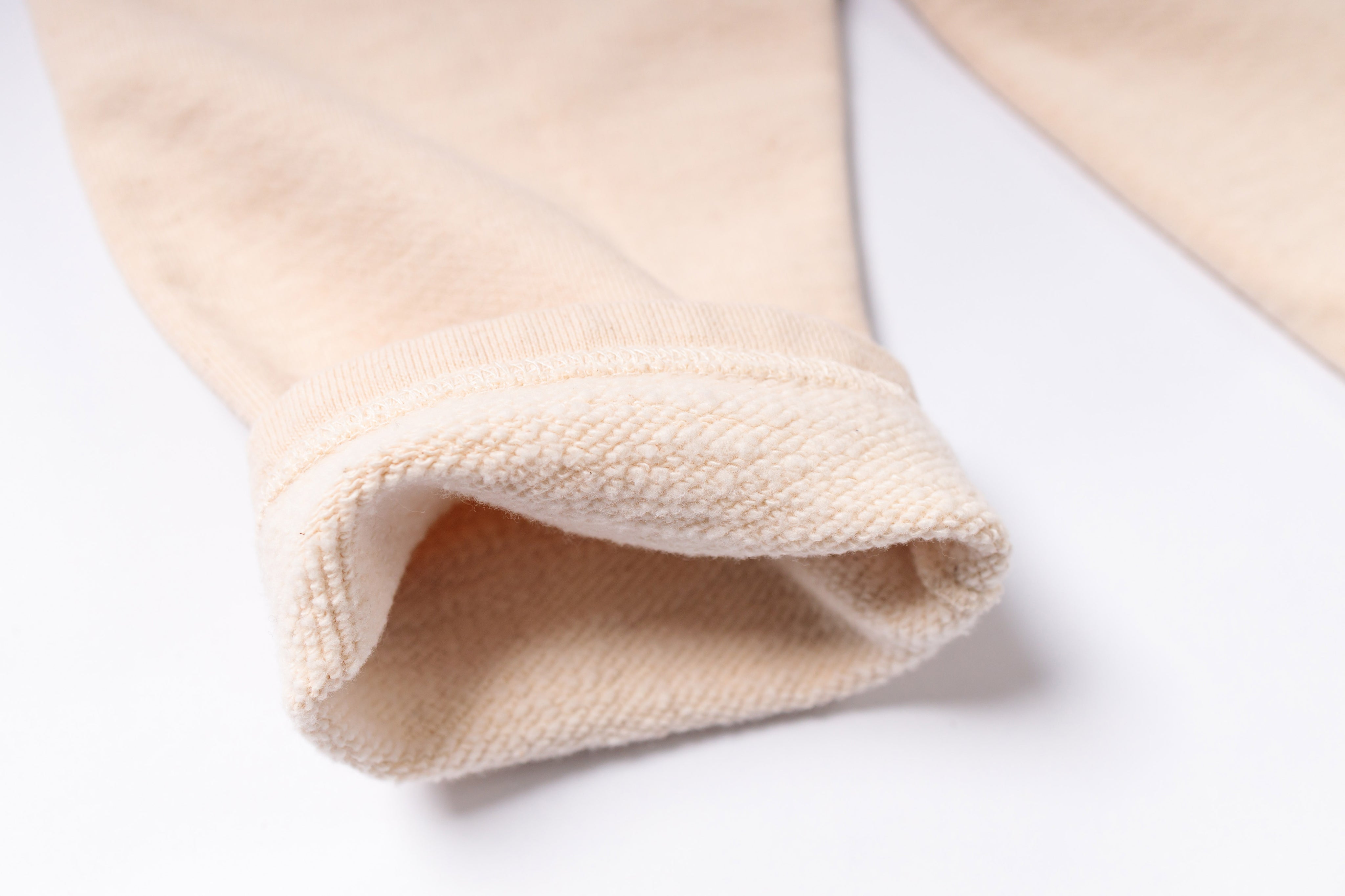Close-up of beige fabric on a white background