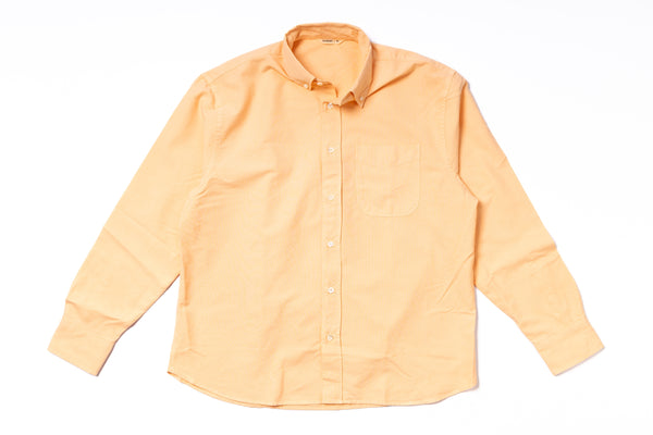 Orange shirt with collar and buttons on a white background
