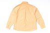 Back view of a light orange shirt on a white background