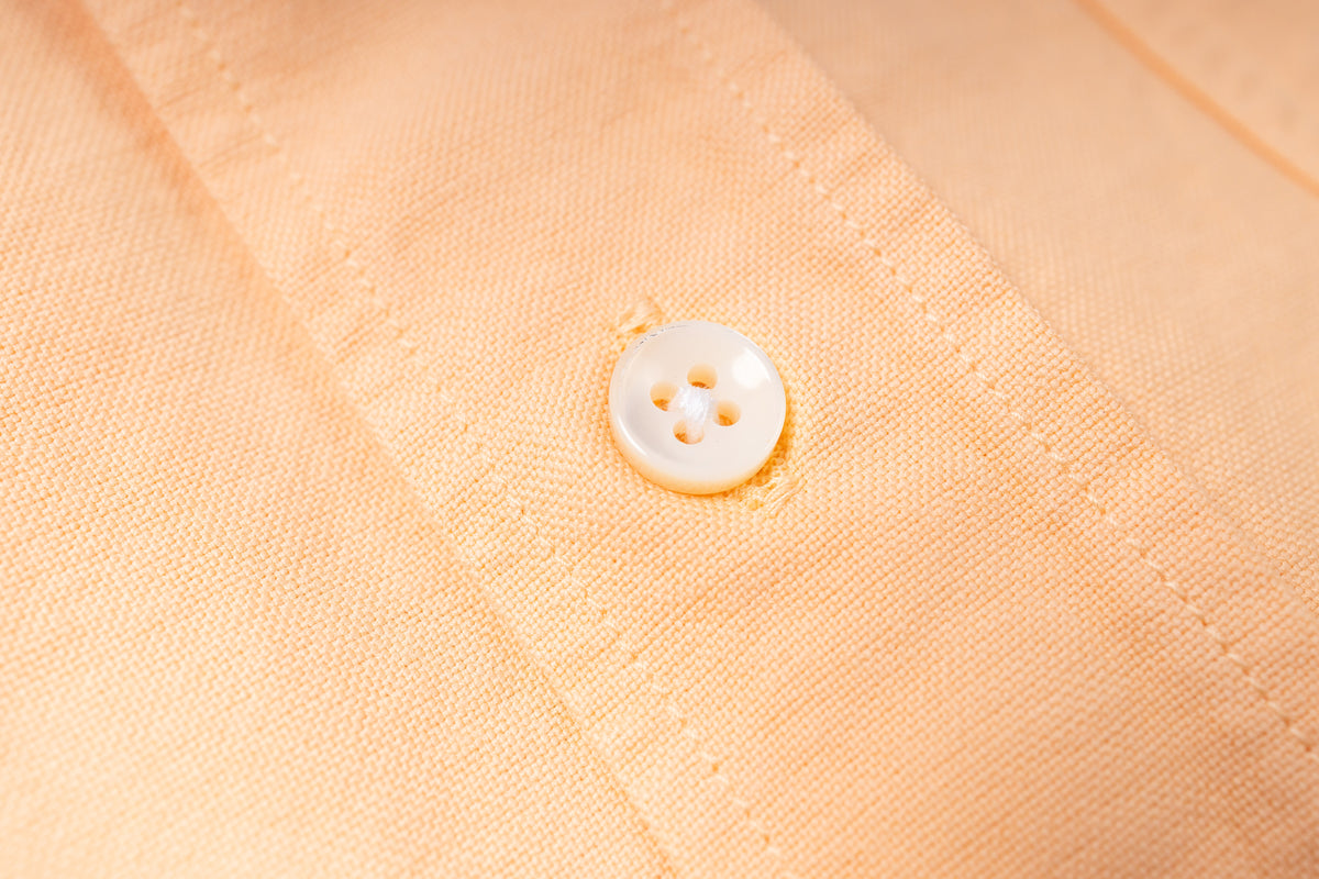 Close-up of a button on beige fabric
