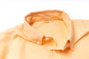 Orange shirt with collar and buttons on a white background