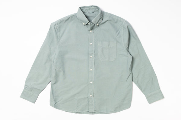 Light green button-up shirt on a white background