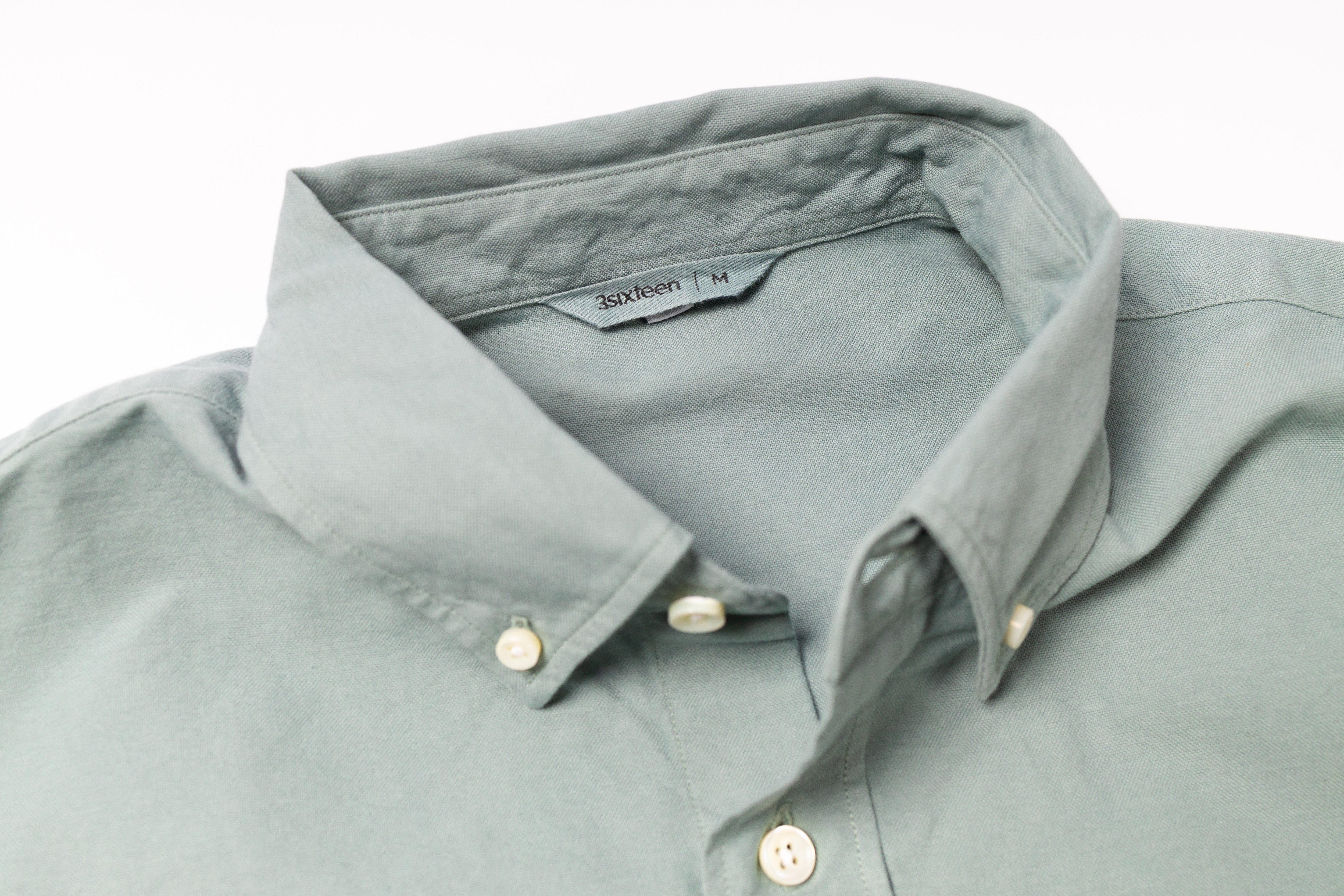 Green shirt with collar and buttons on a white background