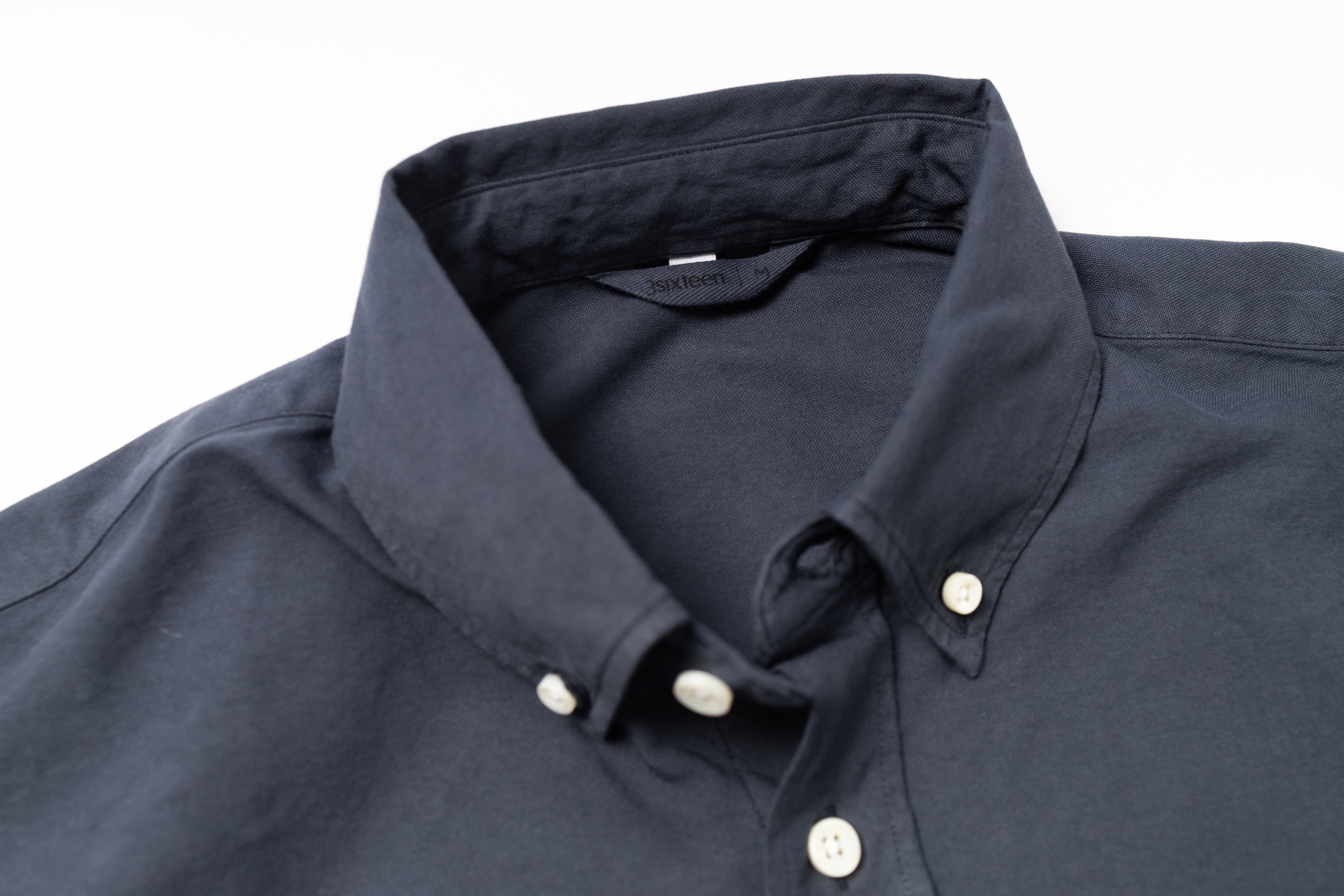 Dark blue shirt with collar and buttons on a white background
