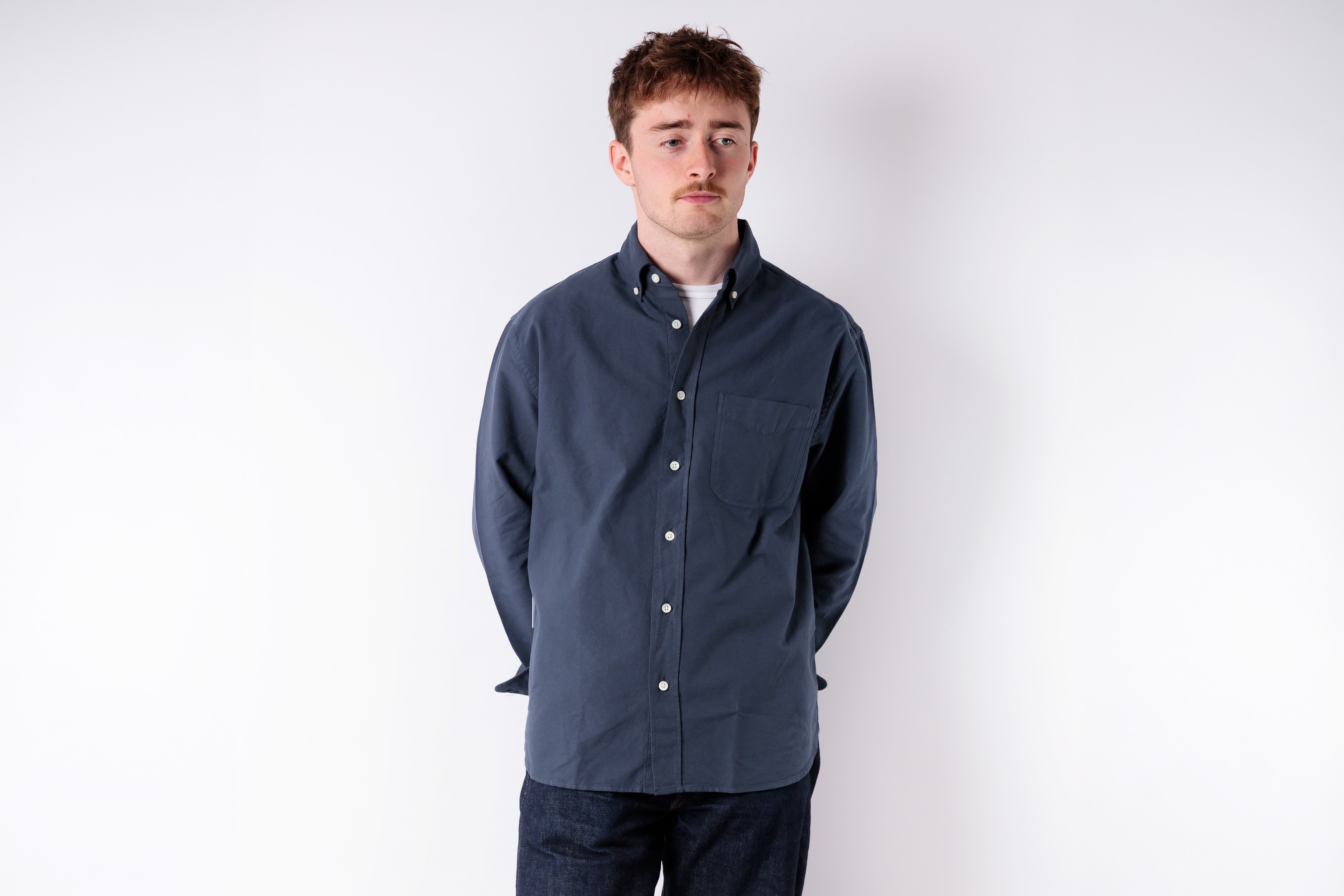 Man wearing a blue jacket on a white background