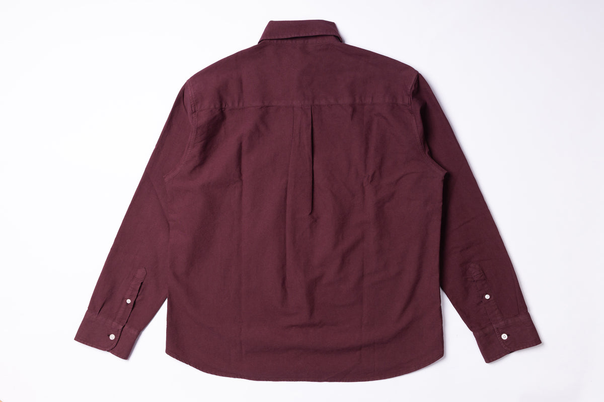 A long-sleeve button-up shirt in a deep burgundy or maroon color, shown from the back on a clean white background.