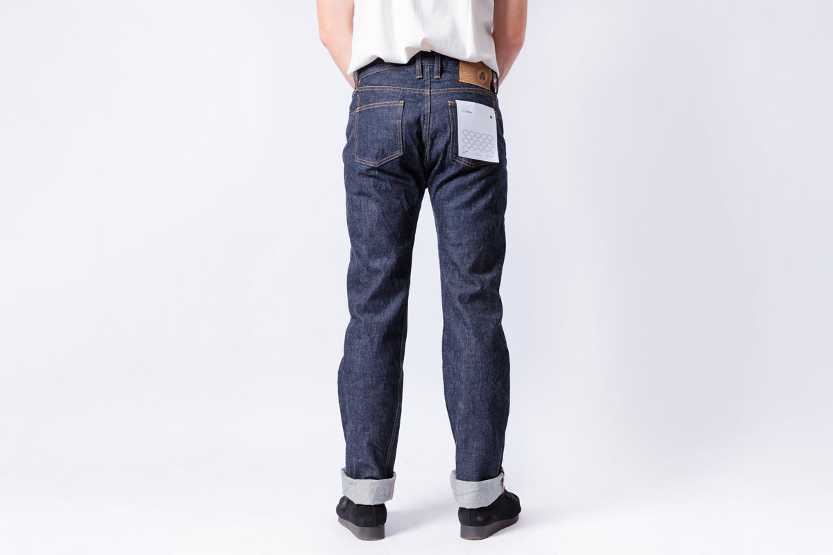 Person wearing blue jeans on a white background