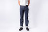 Person wearing dark blue jeans and a white shirt on a white background