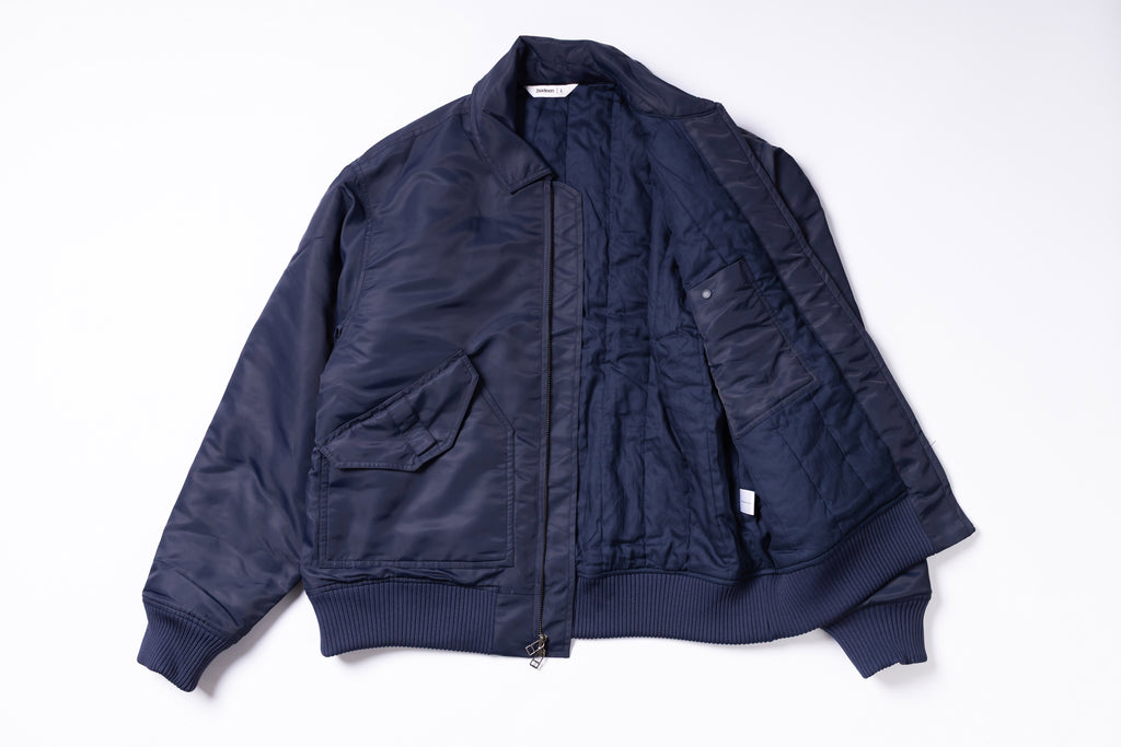 Navy blue bomber jacket on a white background