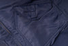 Close-up of a navy blue jacket with a zipper and pocket