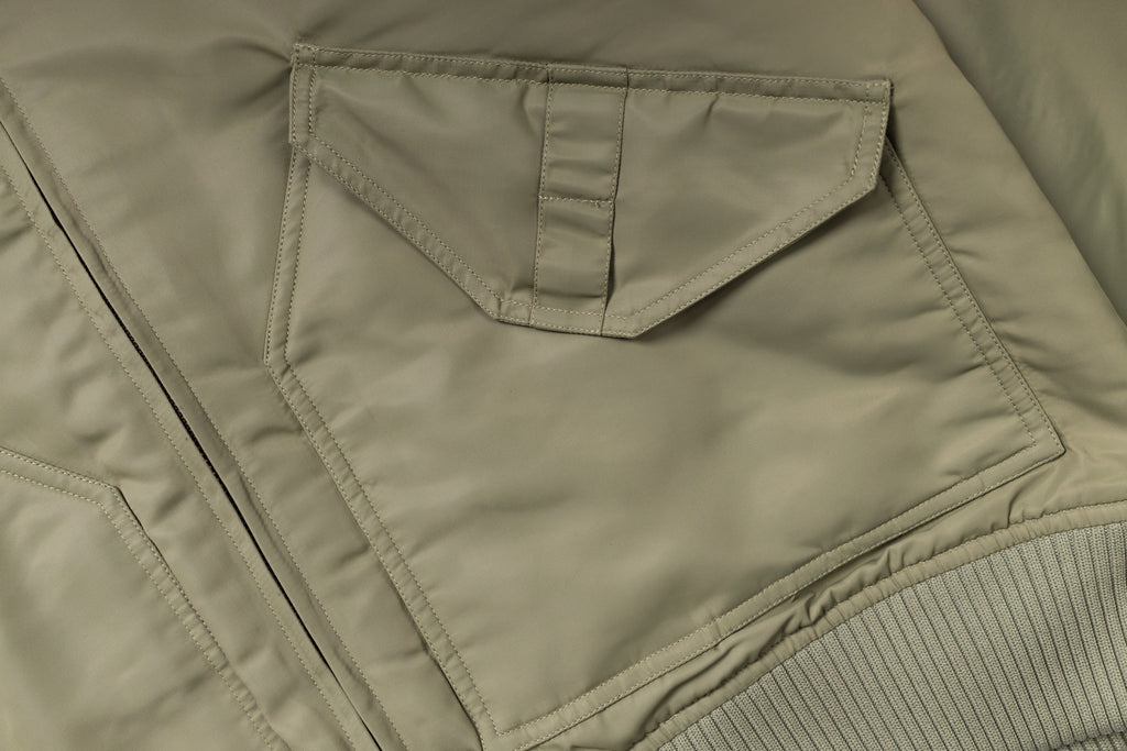 Close-up of a green jacket with a pocket