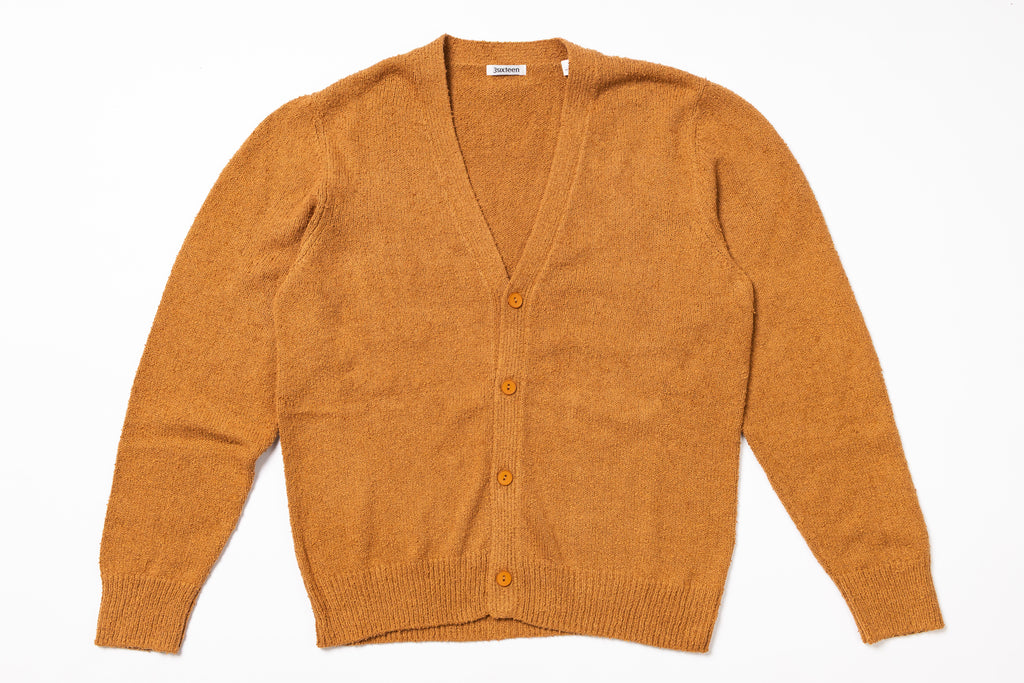 Orange cardigan on a white background