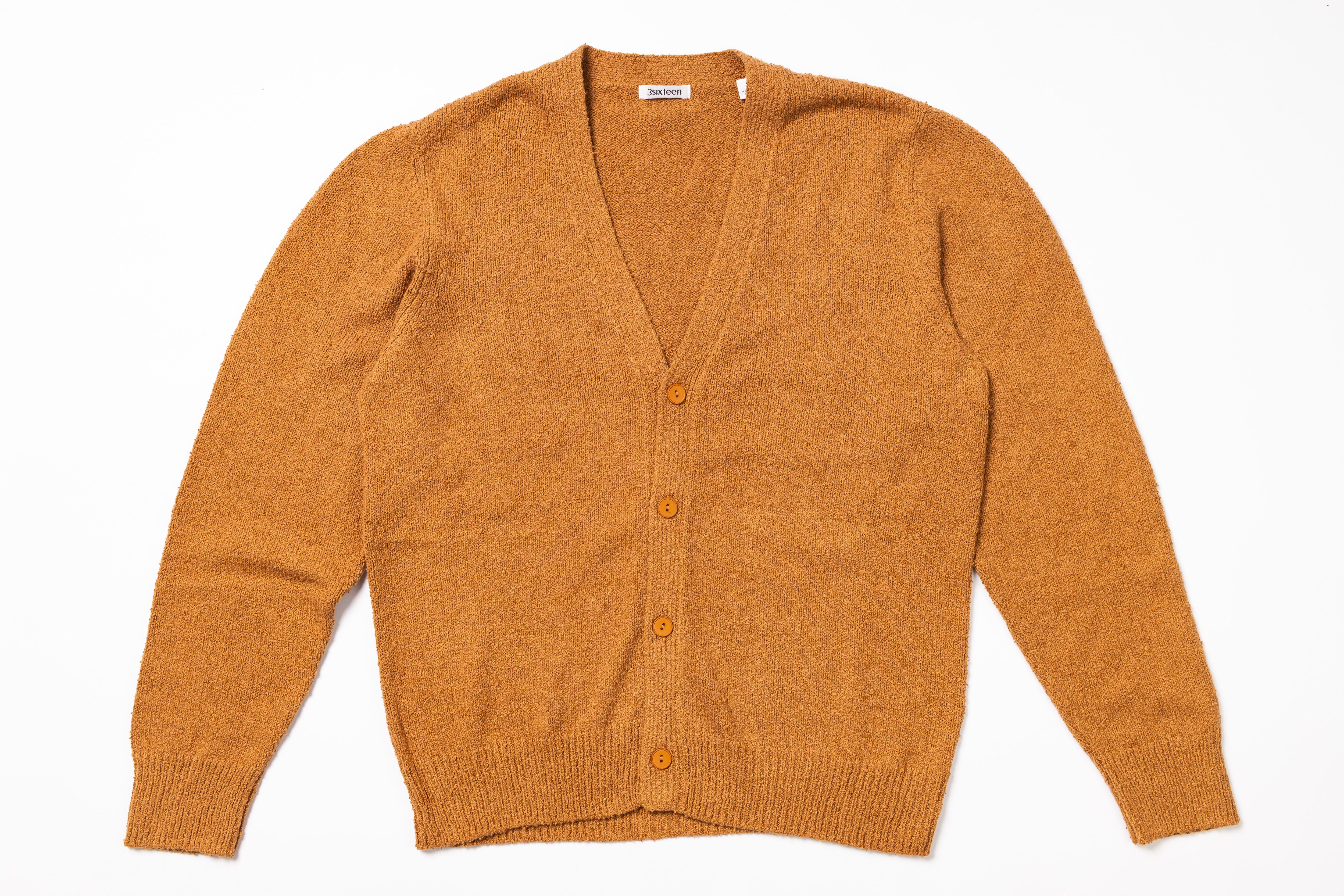 Orange cardigan on a white background