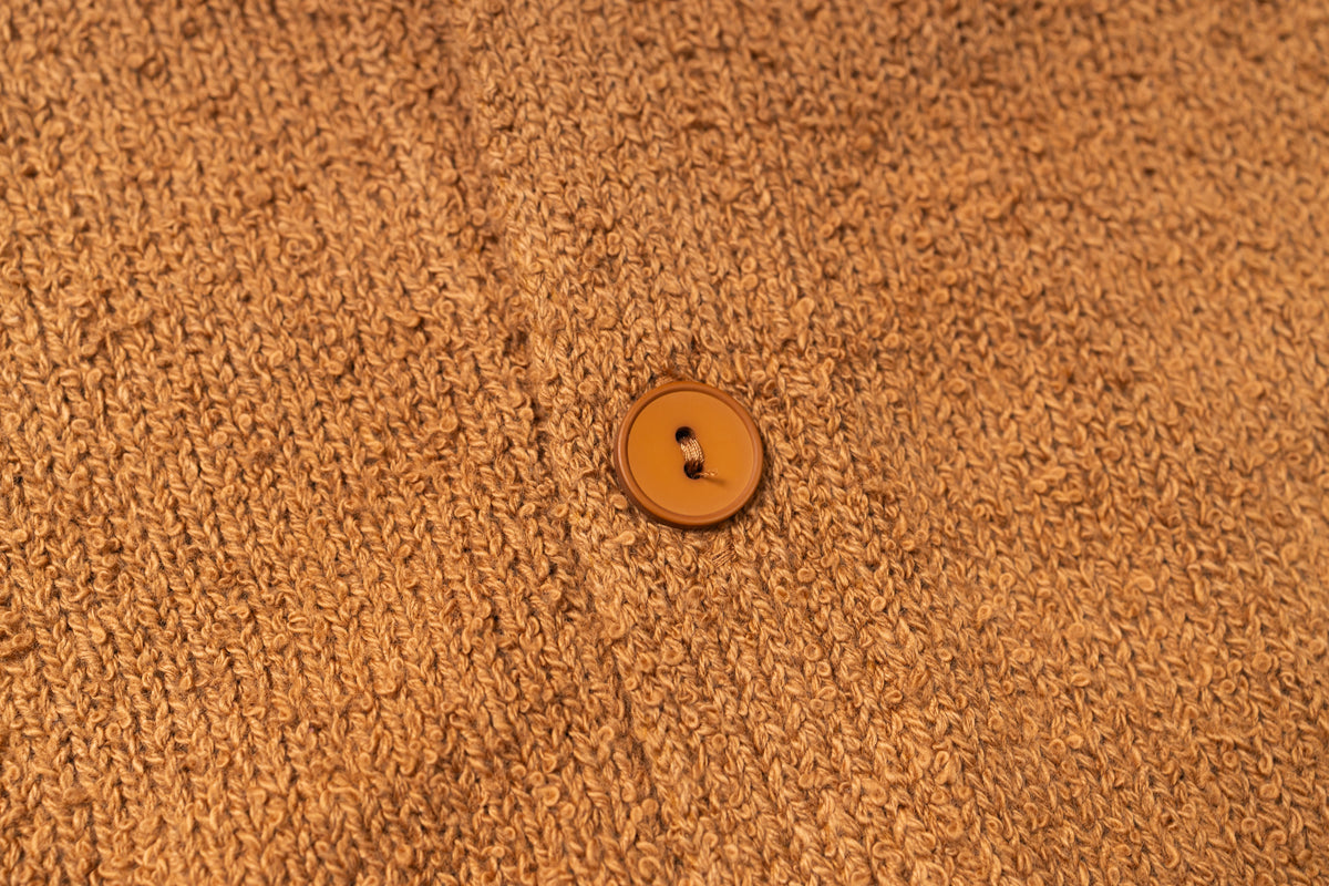Brown textured fabric with a single button in the center