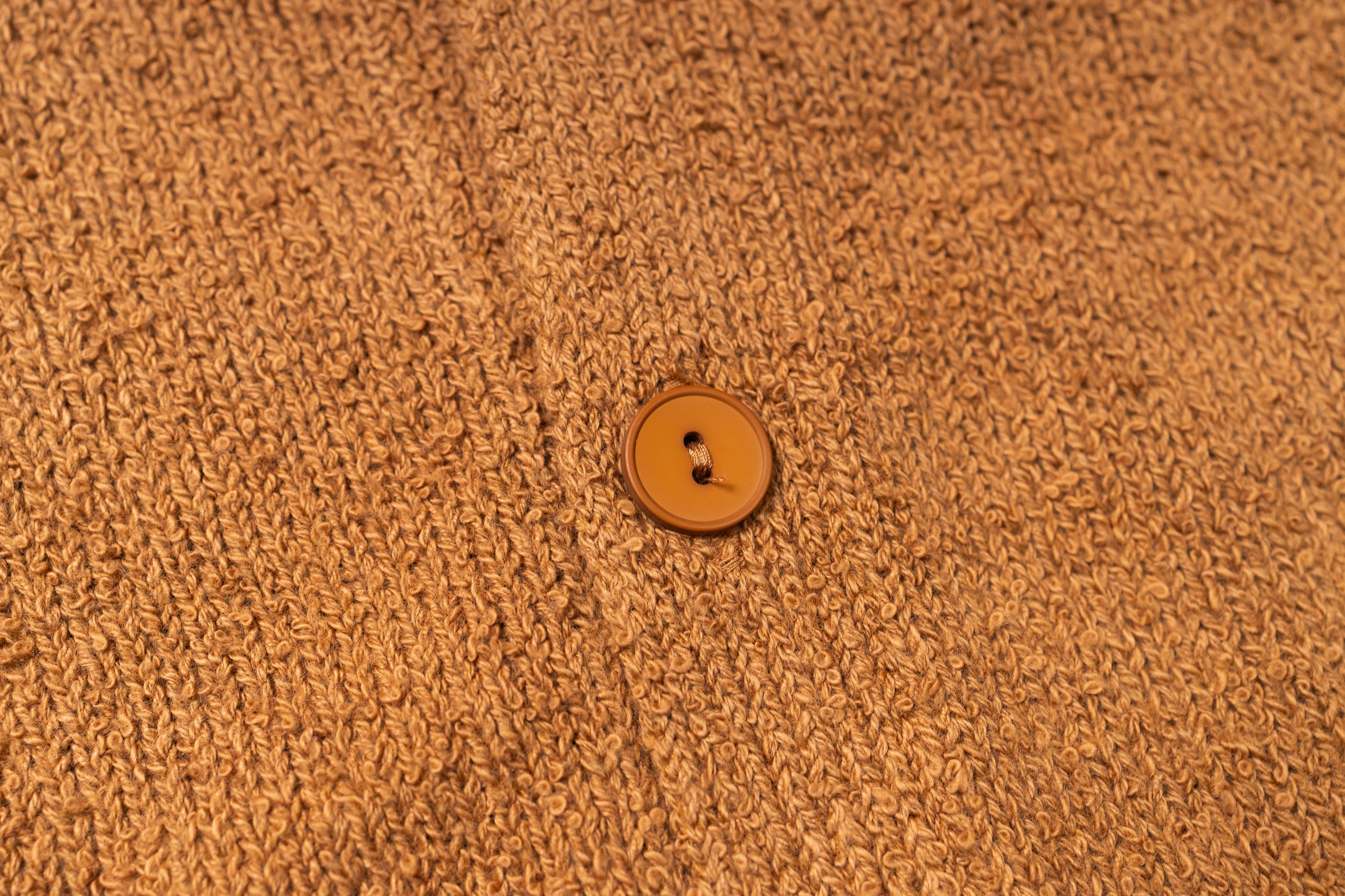 Brown textured fabric with a single button in the center