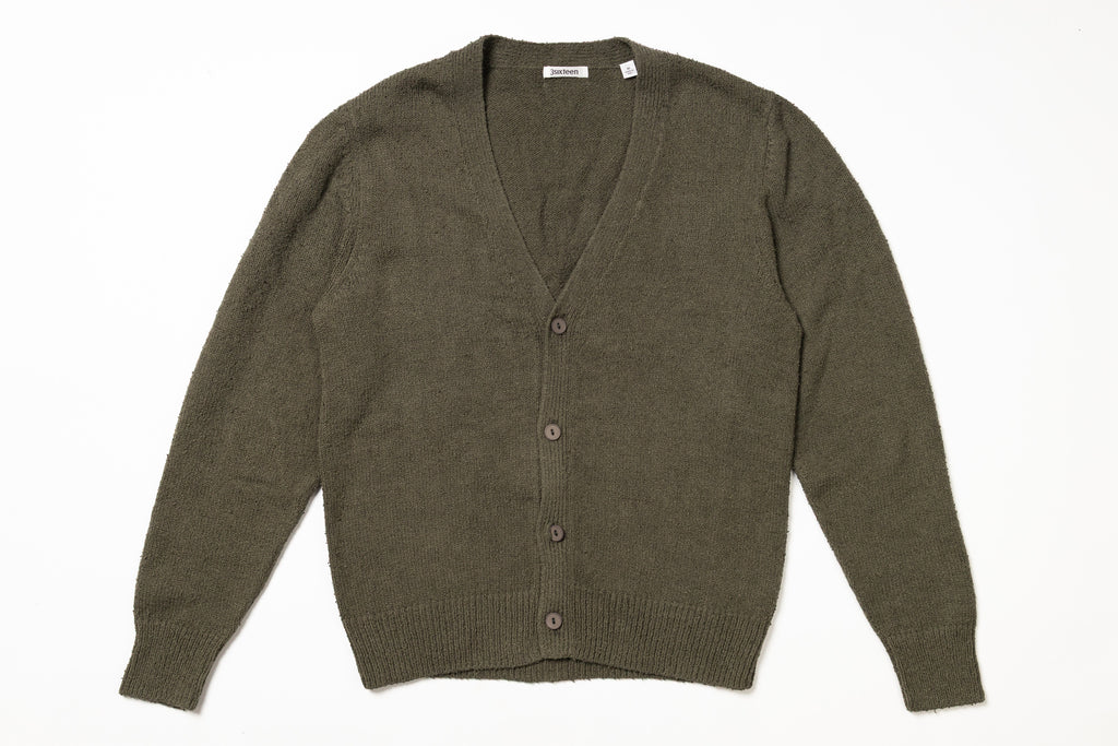 Green cardigan on a white background