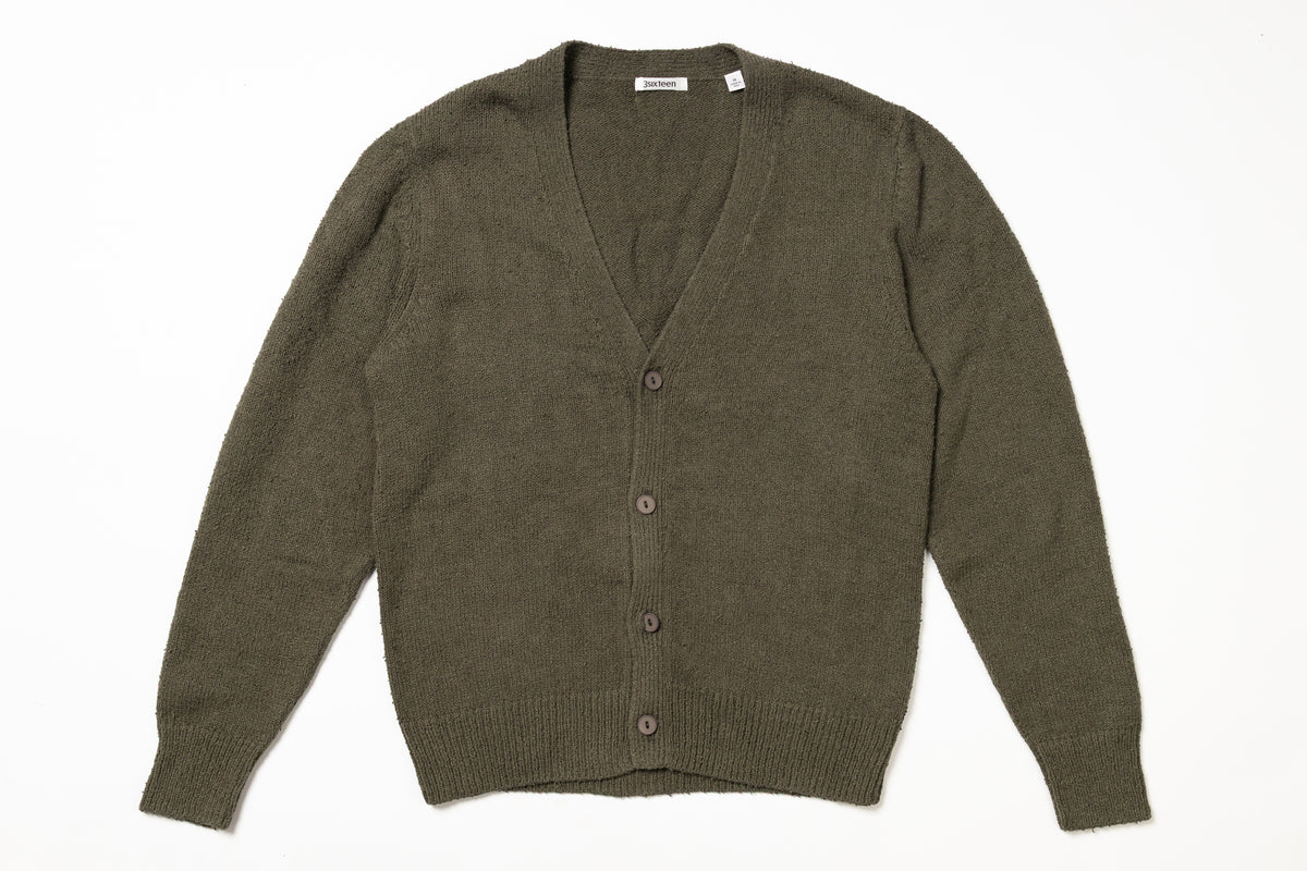 Green cardigan on a white background