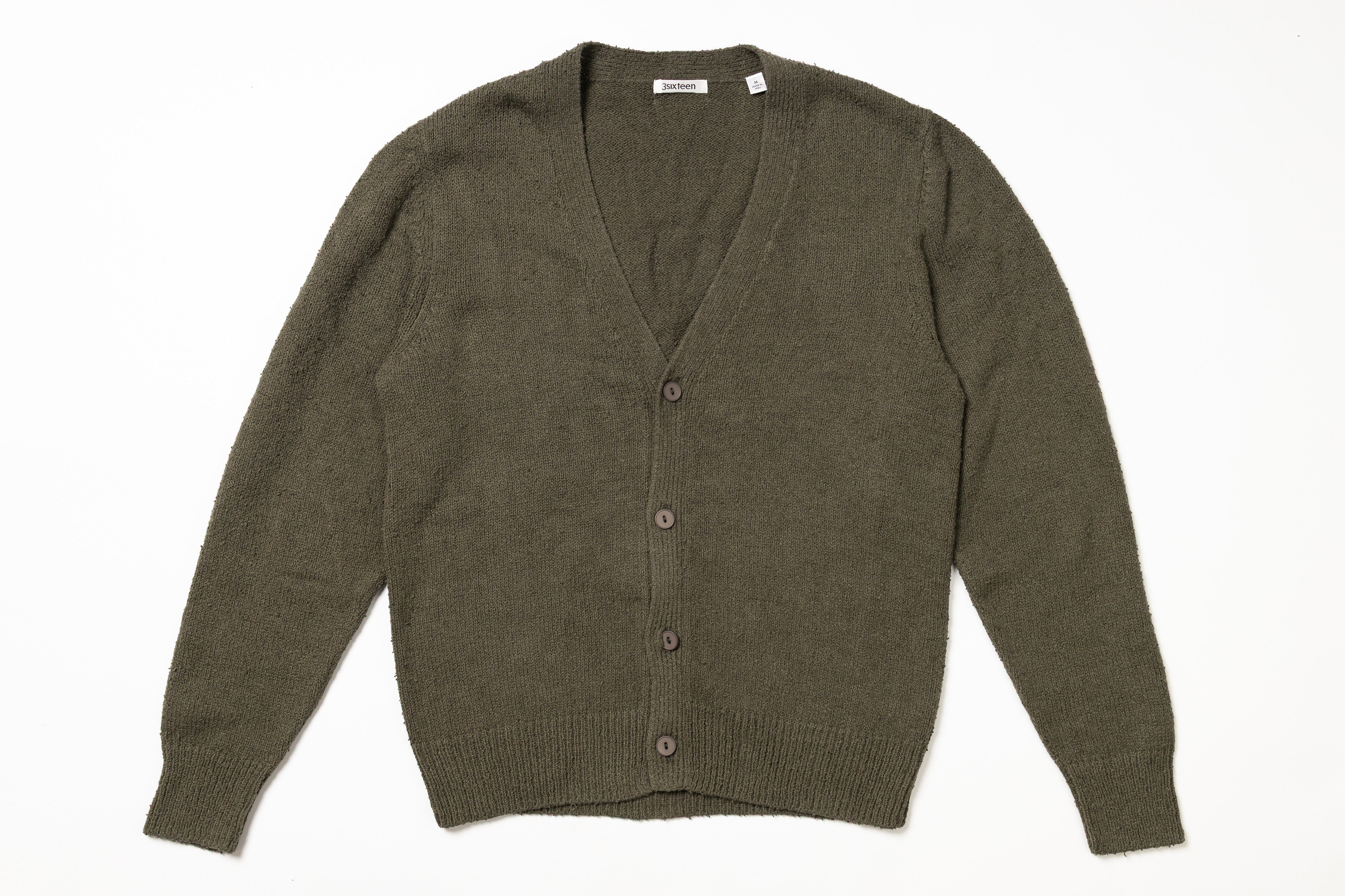 Green cardigan on a white background