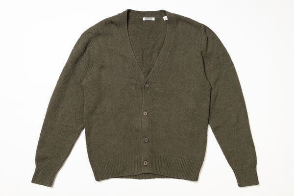 Green cardigan on a white background