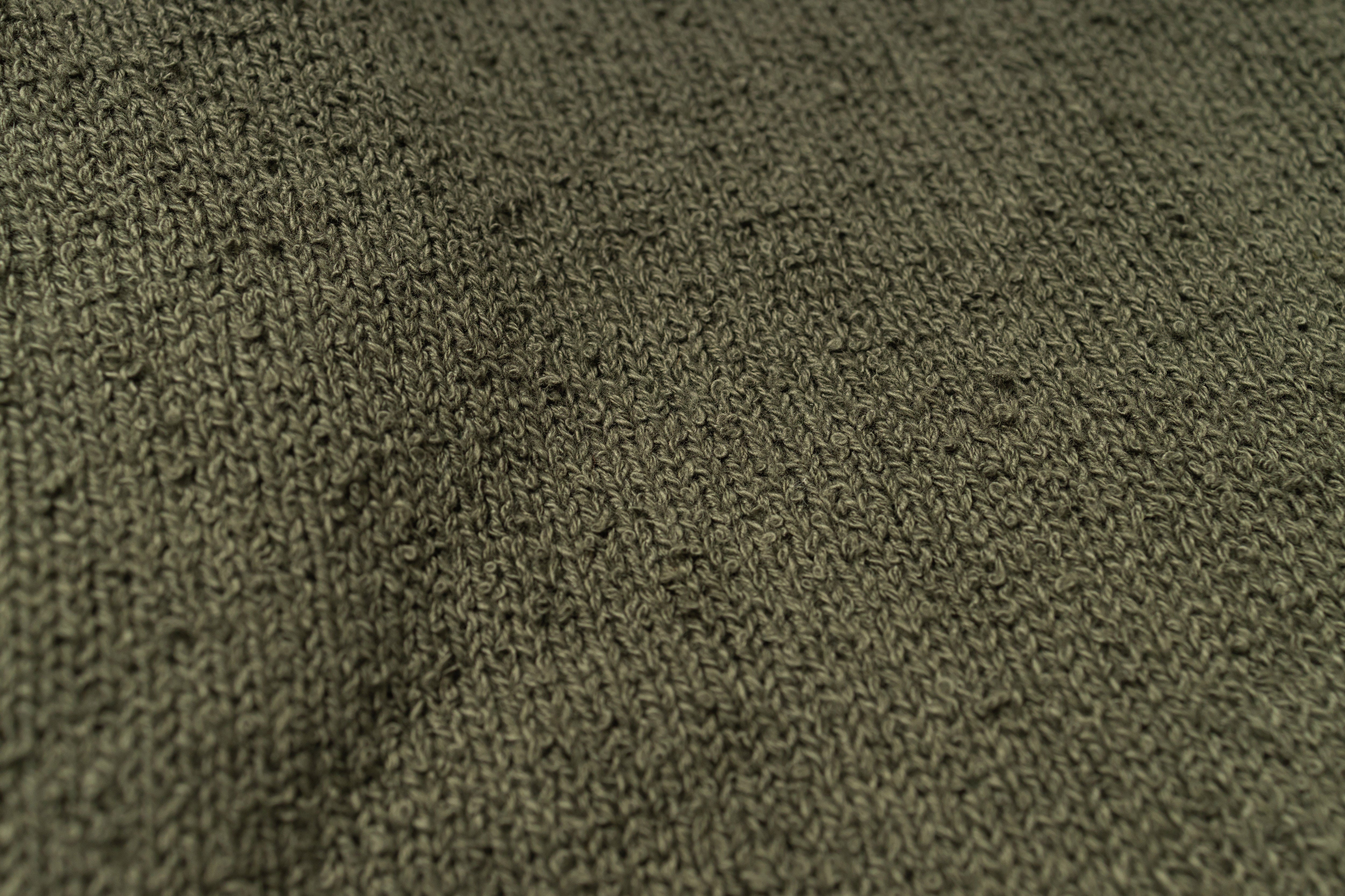 Close-up of a textured green fabric surface