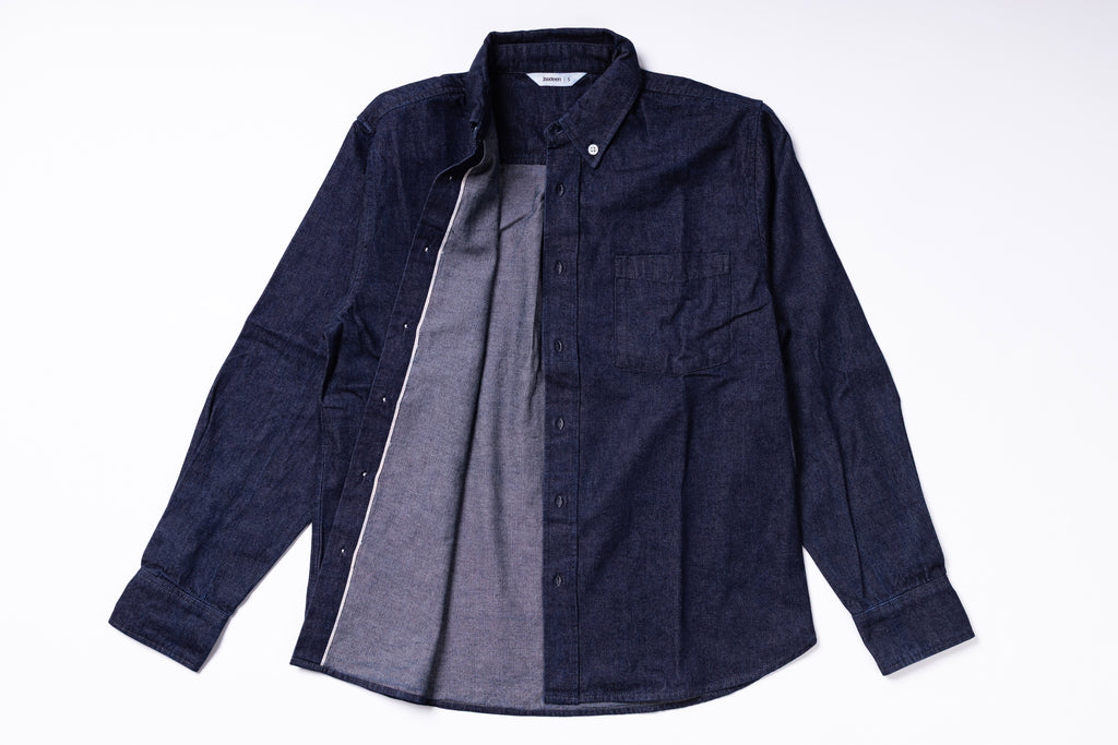Dark denim shirt with a gray shirt underneath on a white background