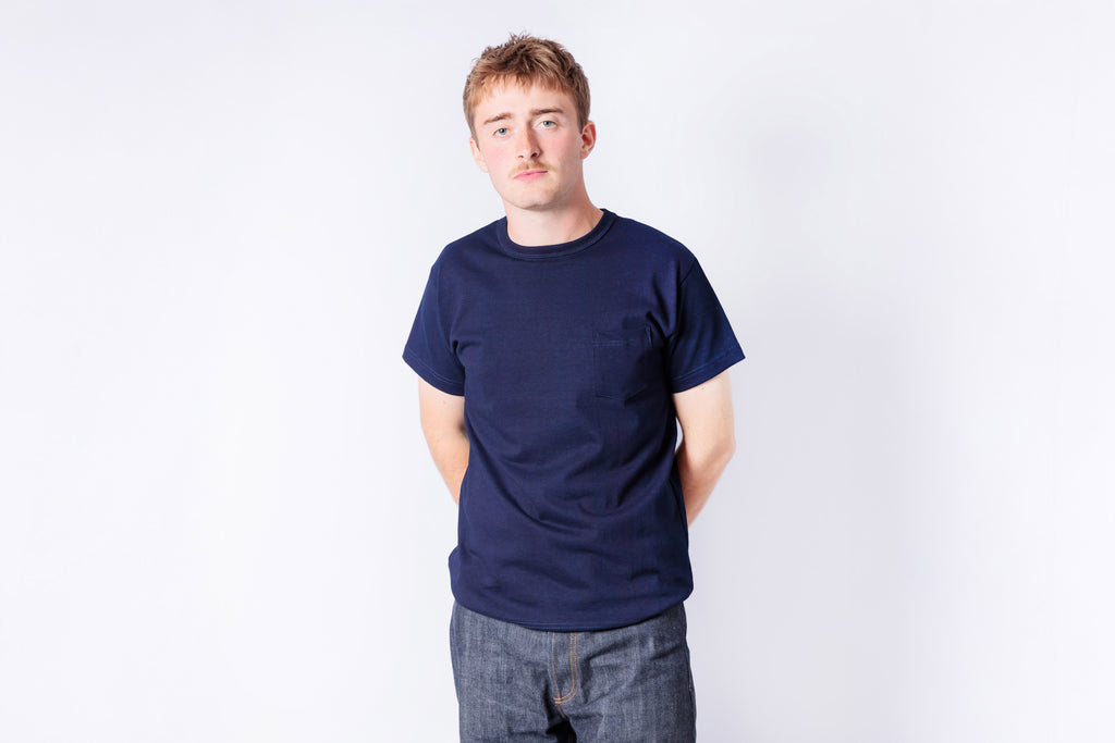 Person wearing a navy blue t-shirt on a white background