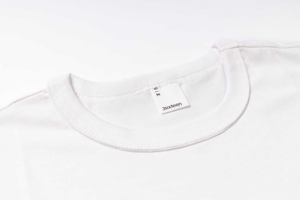 White t-shirt with a brand label on a white background