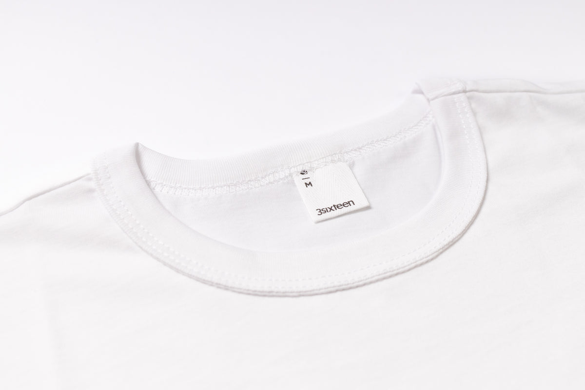 White t-shirt with a brand label on a white background