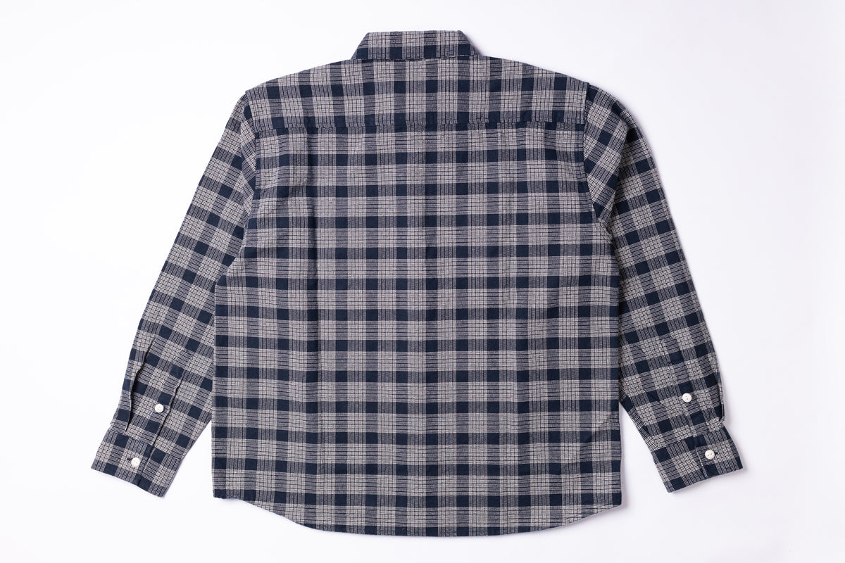 A long-sleeve plaid button-up shirt shown from the back, featuring a dark navy and gray checkered pattern on a white background.