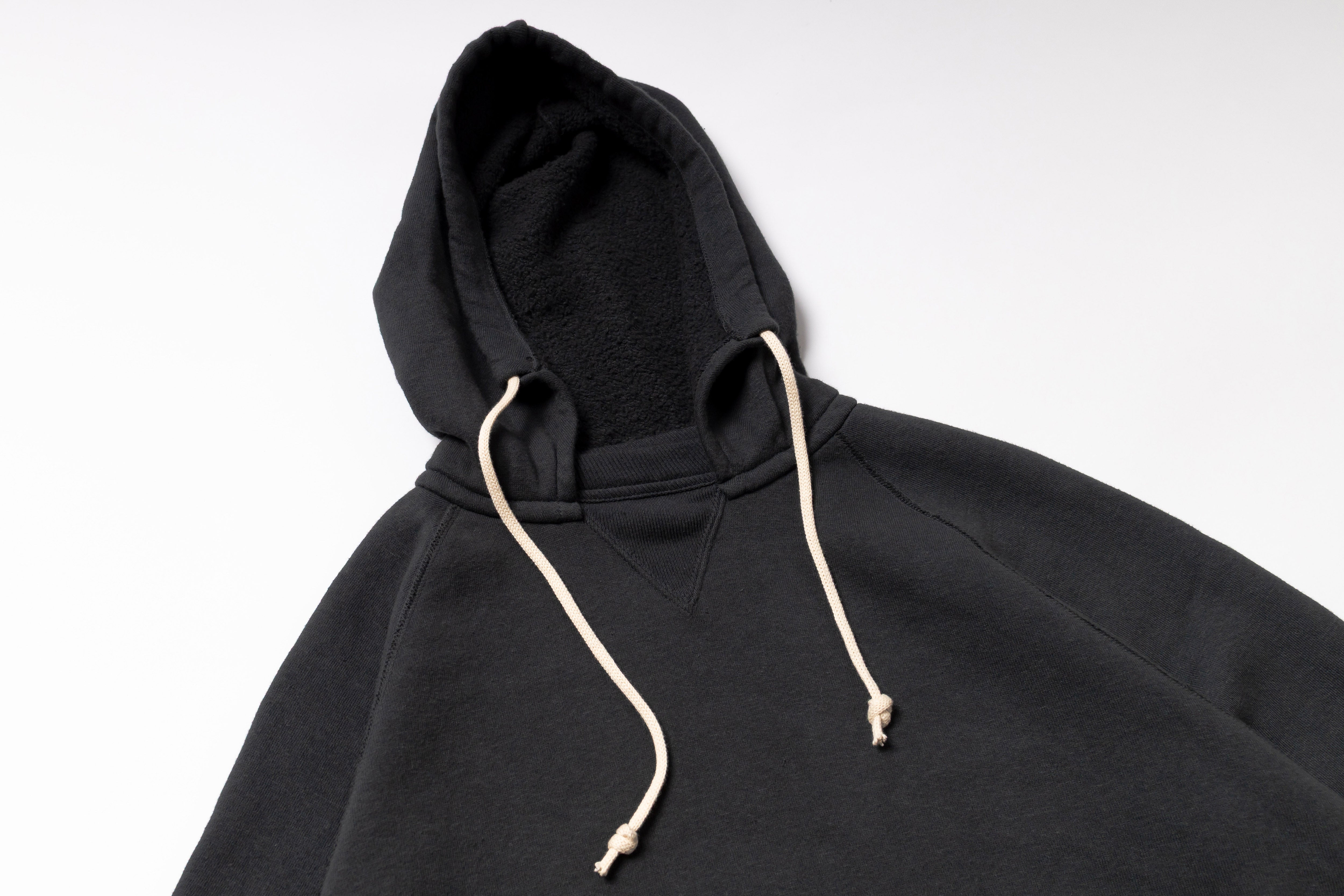 Black hoodie with beige drawstring on a white background