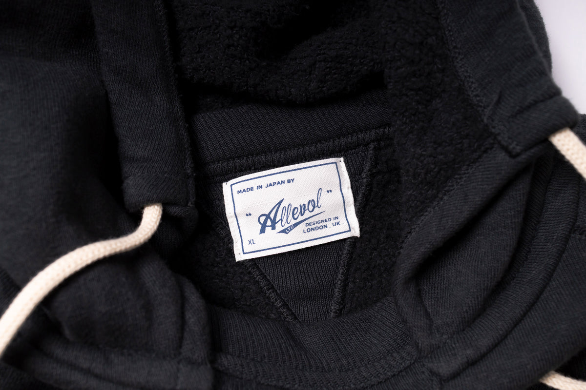 Black jacket with a visible label on a white background