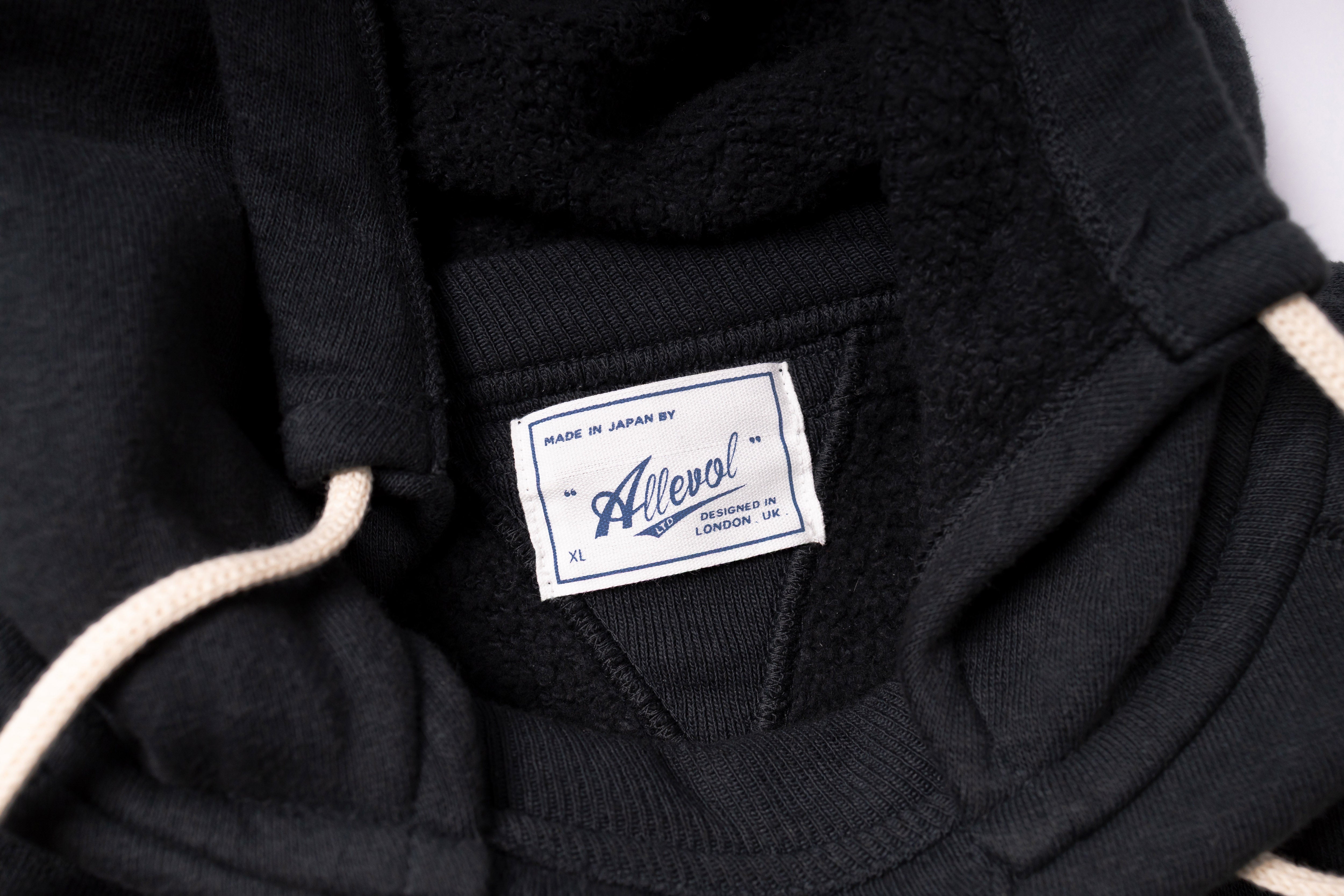 Black jacket with a visible label on a white background