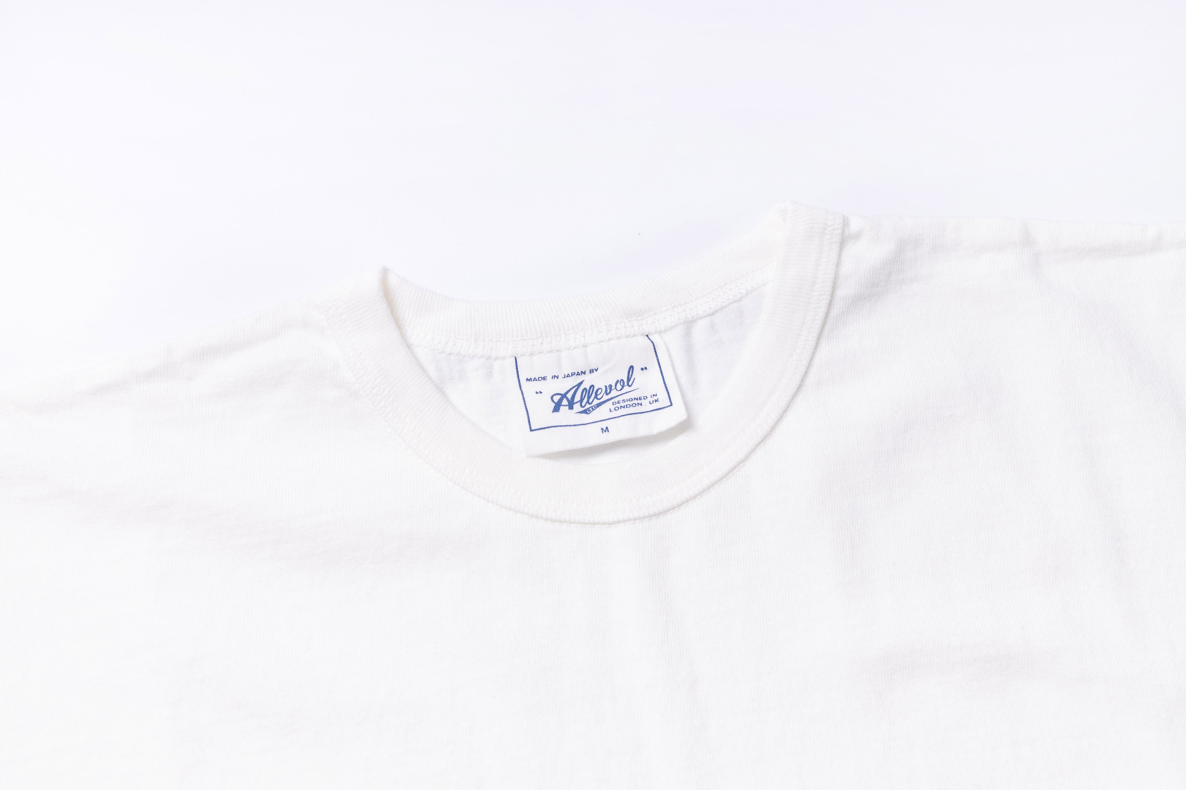 White t-shirt with a brand label on a white background