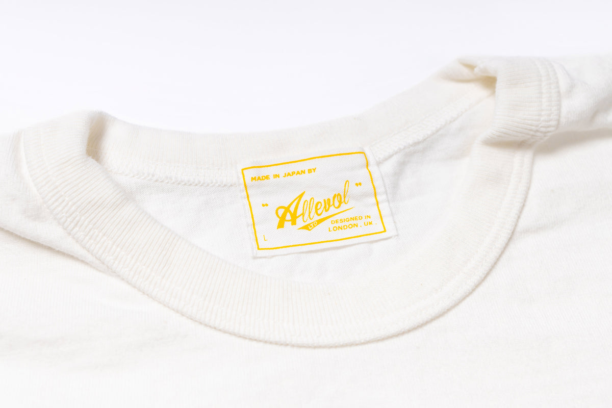 Close-up of a white garment with a yellow label on a white background
