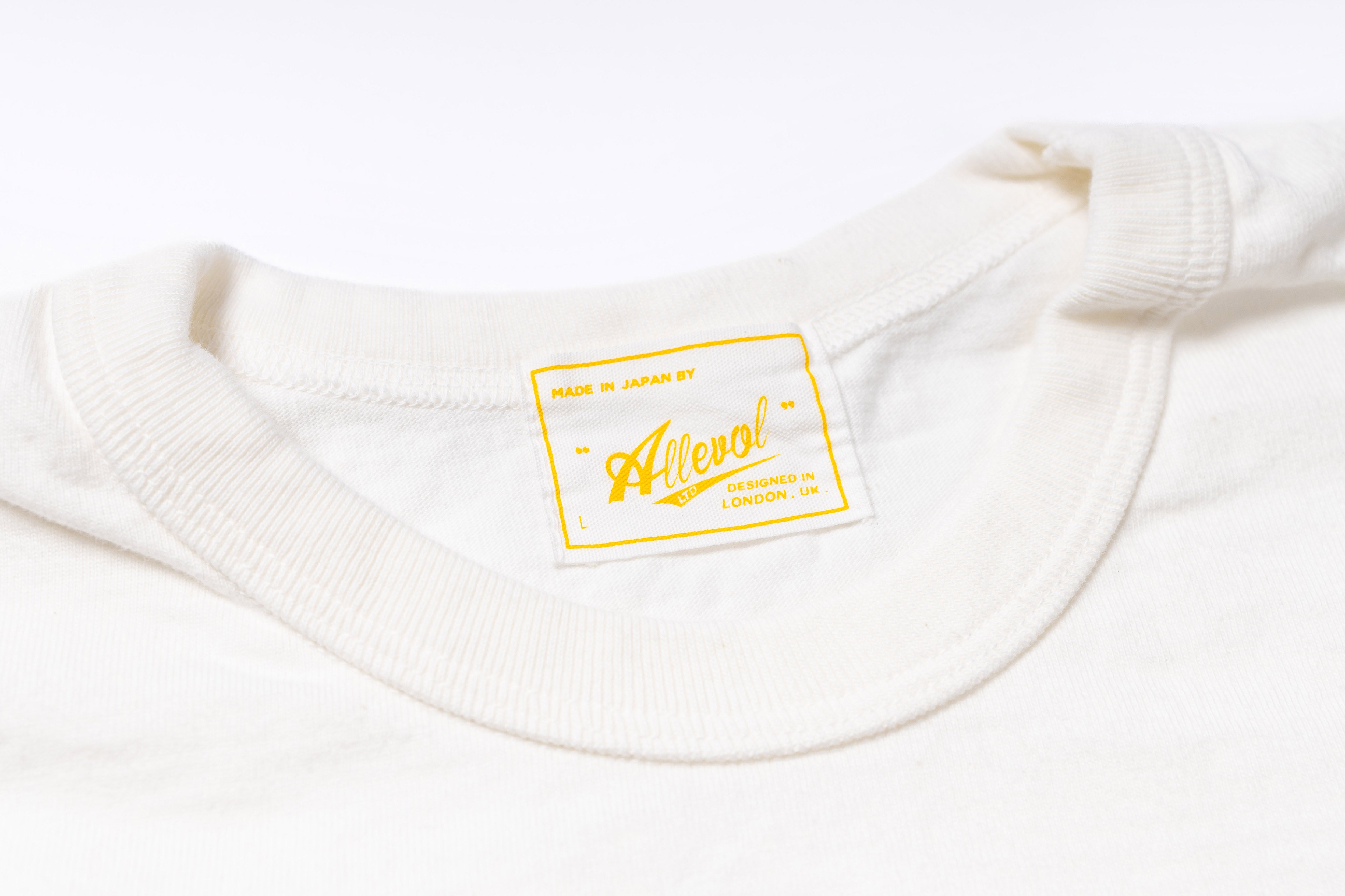 Close-up of a white garment with a yellow label on a white background