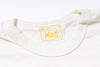 Close-up of a white garment with a yellow label on a white background