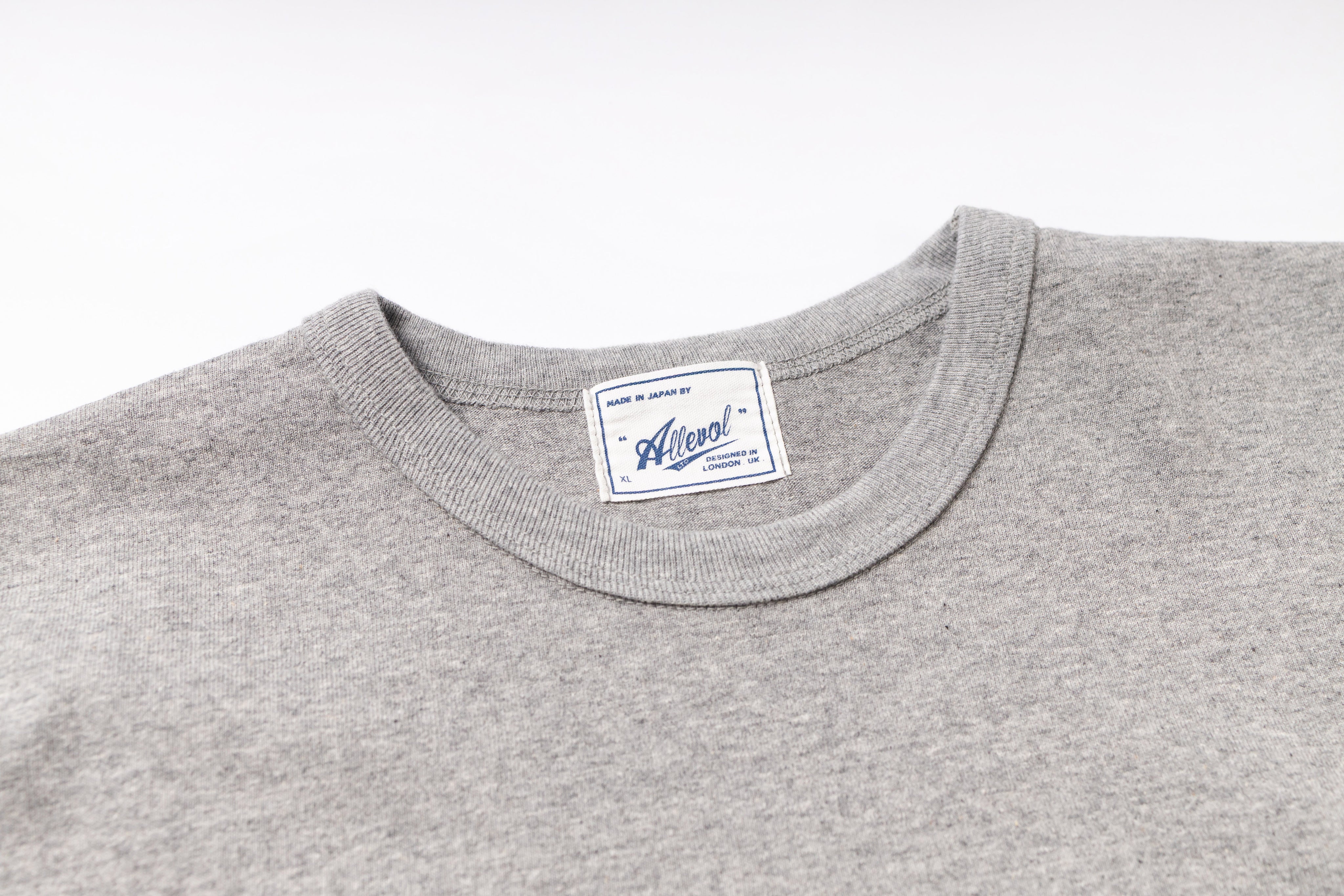Gray sweatshirt with a brand label on a white background