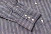 Close-up of a blue striped shirt with buttons