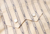Close-up of a beige fabric with blue stripes and white buttons