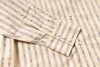 Close-up of a beige shirt with blue stripes and buttons.