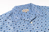 Blue patterned shirt with a brand label on a white background