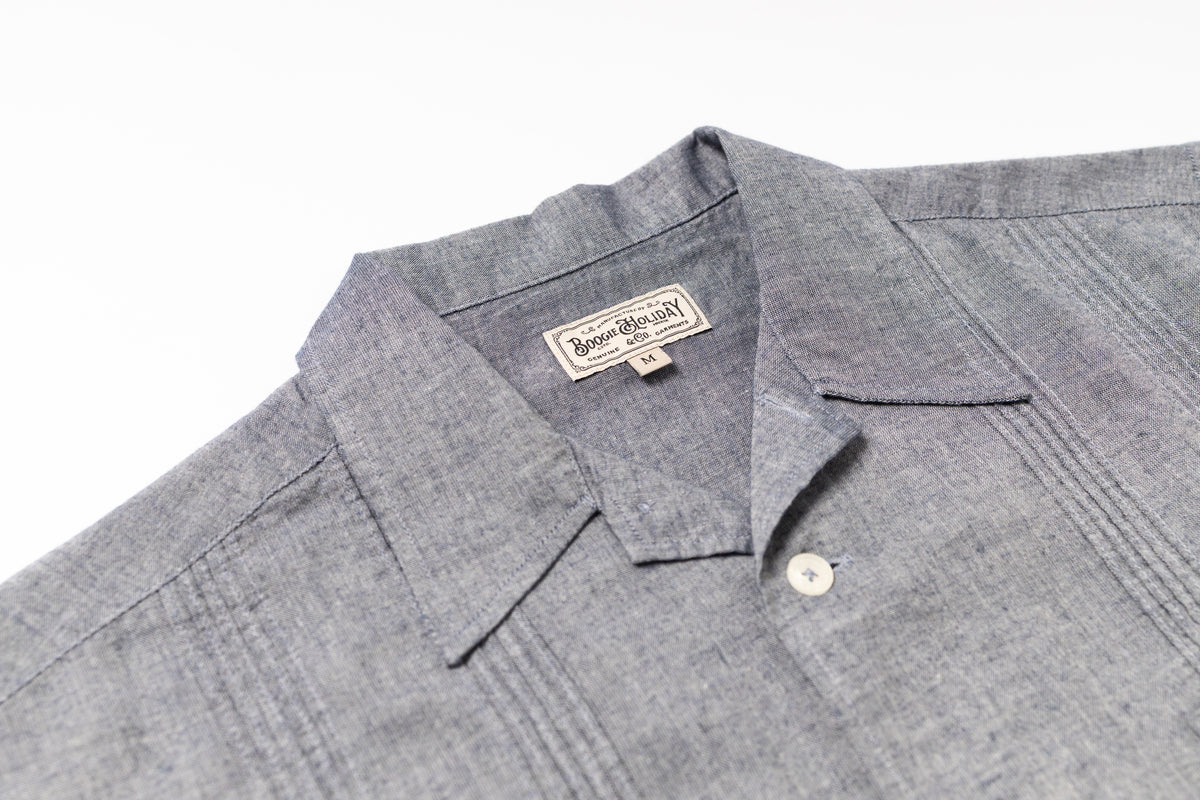 Gray shirt with a brand label on a white background