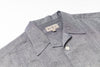 Gray shirt with a brand label on a white background