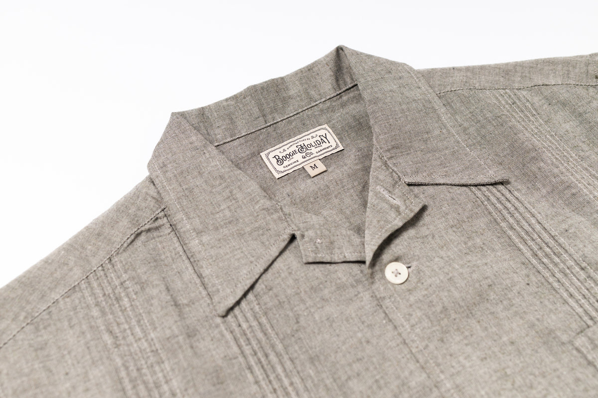 Gray shirt with a brand label on a white background