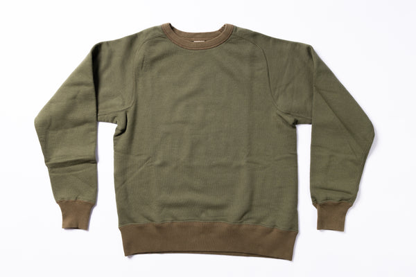 Green sweatshirt with brown trim on a white background