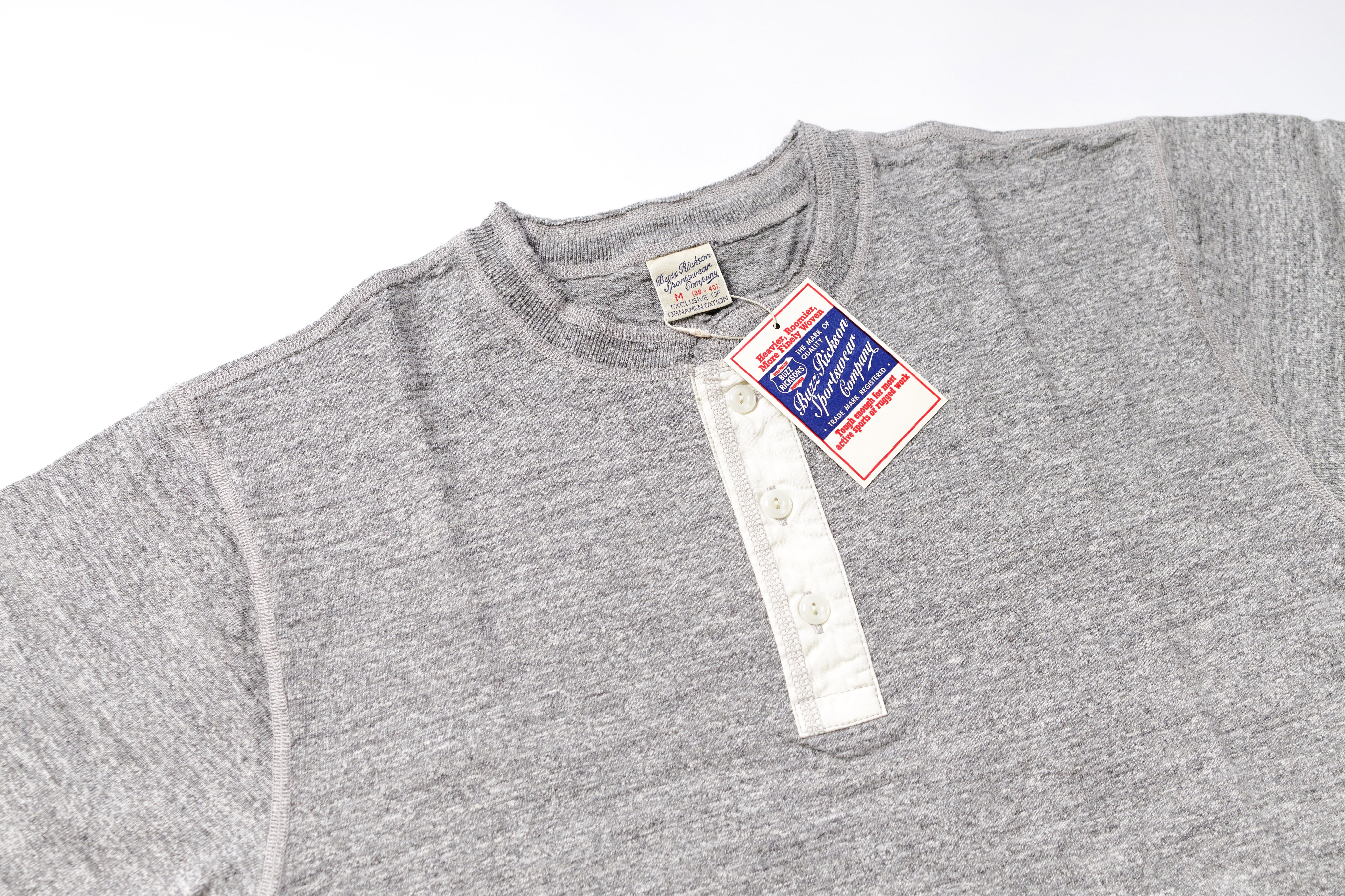 Gray t-shirt with a tag on a white background