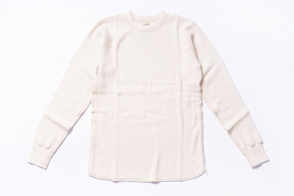 White long-sleeve shirt on a light gray background